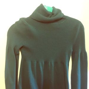 Dark green baby doll turtleneck sweater.